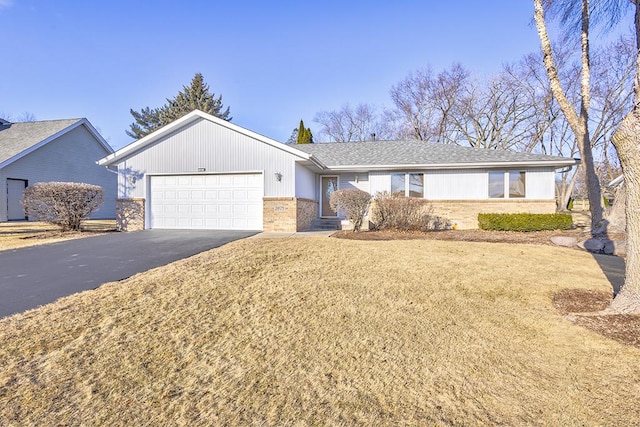 ranch-style house with a garage, brick siding, and driveway