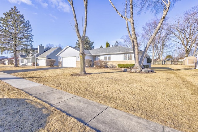 single story home with an attached garage and a residential view