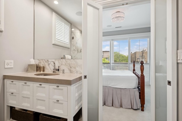 ensuite bathroom featuring connected bathroom, vanity, and walk in shower