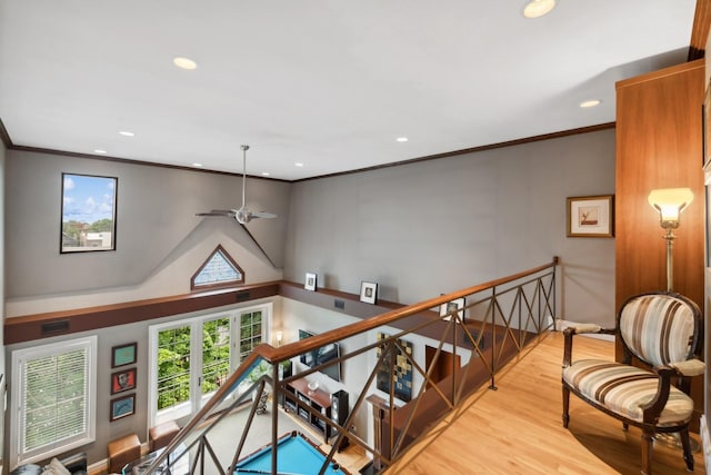 interior space with ornamental molding, recessed lighting, an upstairs landing, and wood finished floors