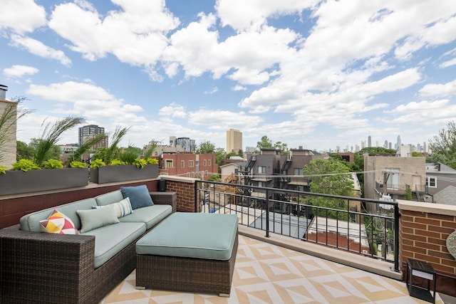 view of patio featuring a view of city, a balcony, and an outdoor hangout area