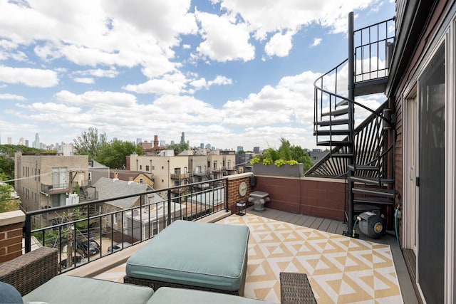 view of patio / terrace featuring stairway, a balcony, and a city view