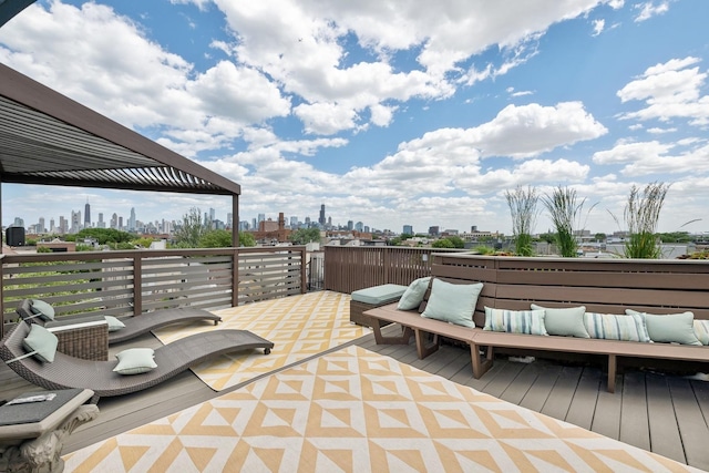 view of patio / terrace featuring a view of city, outdoor lounge area, and a deck