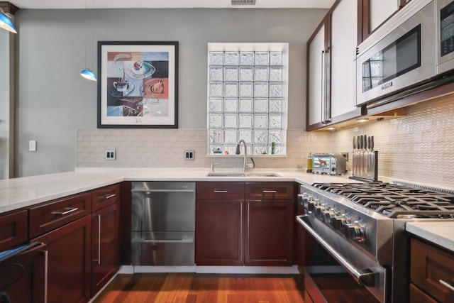 kitchen with visible vents, appliances with stainless steel finishes, light countertops, and a sink