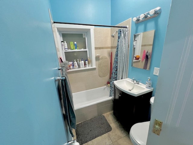 bathroom with toilet, vanity, tiled shower / bath, and tile patterned floors