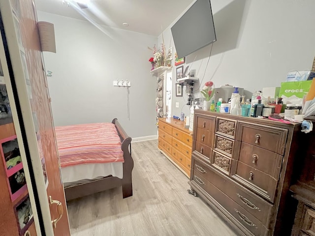 bedroom featuring baseboards and light wood-style floors