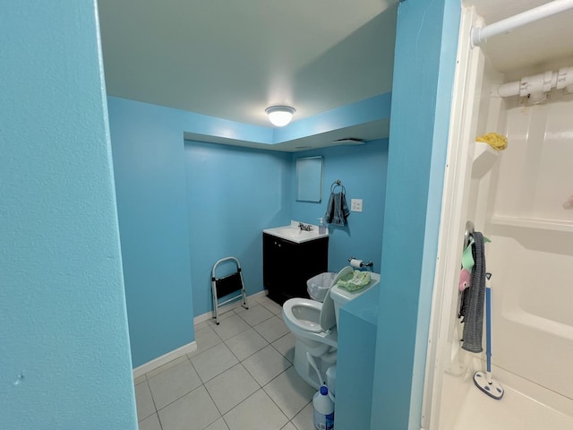 full bathroom with toilet, vanity, baseboards, and tile patterned floors