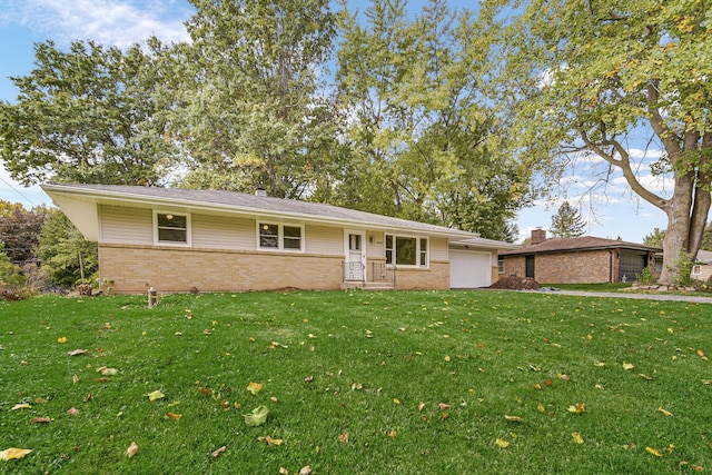 ranch-style house featuring an attached garage, a front yard, and brick siding