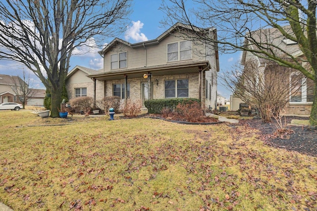 traditional home with a front lawn, central AC, and brick siding