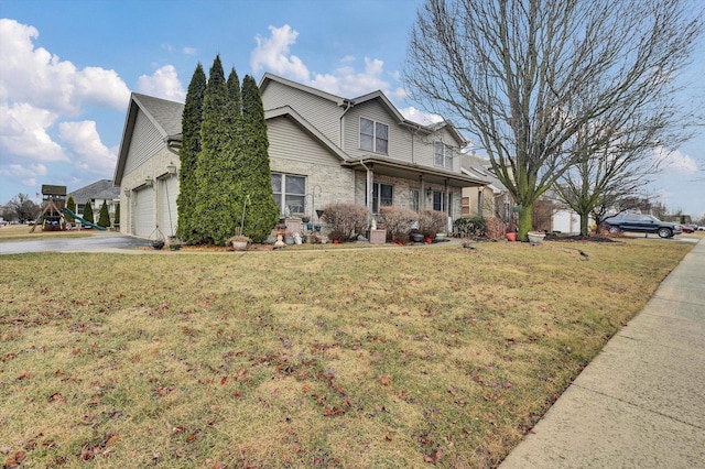 view of front of property with a garage, concrete driveway, a front lawn, and brick siding