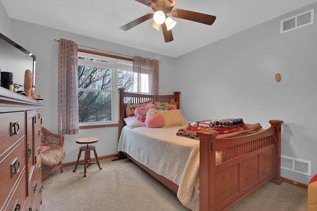 carpeted bedroom featuring baseboards, visible vents, and ceiling fan