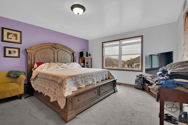 carpeted bedroom featuring baseboards