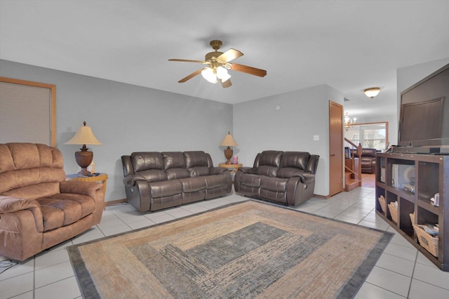 living room with light tile patterned floors, stairs, and a ceiling fan