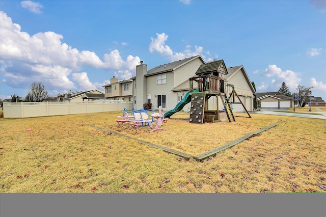 view of playground featuring fence and a lawn