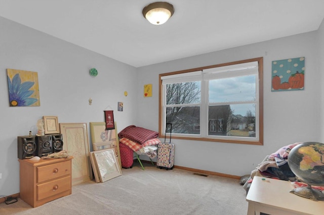 bedroom with baseboards, visible vents, and light colored carpet