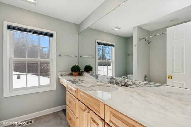 bathroom with toilet, visible vents, baseboards, and vanity