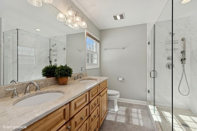 full bath with visible vents, a marble finish shower, baseboards, and a sink