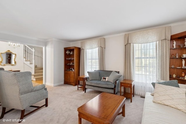 living area with a notable chandelier, ornamental molding, stairway, and light colored carpet