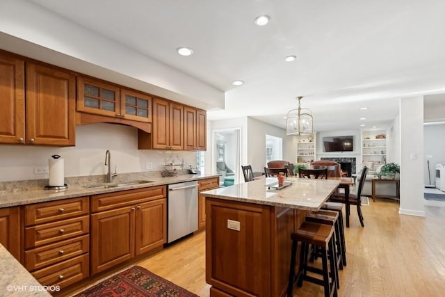 kitchen with a sink, brown cabinets, and dishwasher