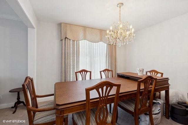 dining area with a chandelier, light colored carpet, and baseboards