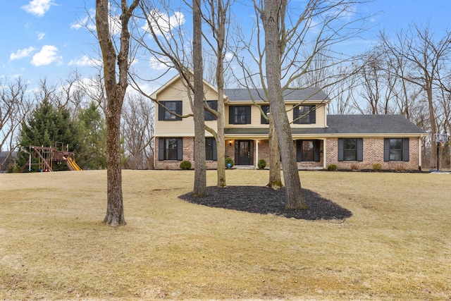 view of front of property featuring a front yard and brick siding