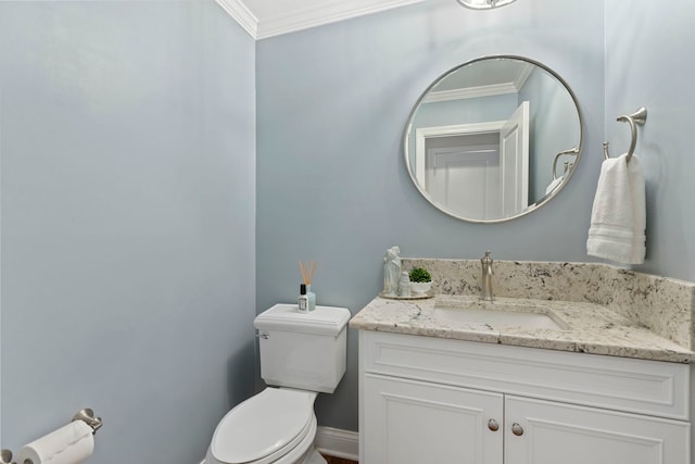 bathroom featuring toilet, baseboards, crown molding, and vanity