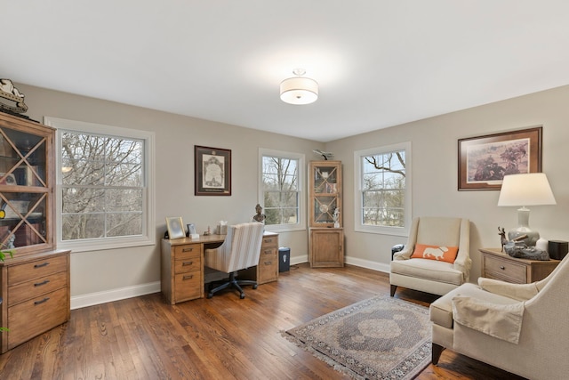 office space with dark wood-type flooring and baseboards