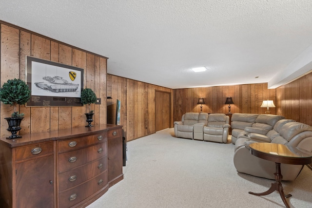 living area with carpet floors, wood walls, and a textured ceiling