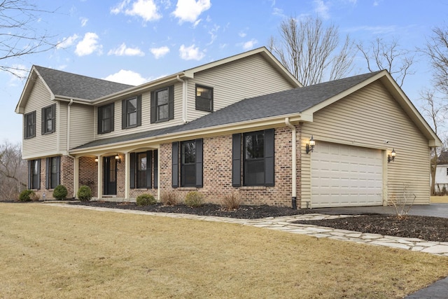 traditional-style house featuring an attached garage, roof with shingles, a front lawn, and brick siding