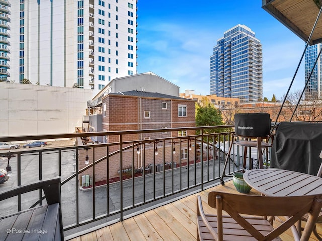 balcony with a view of city and a grill