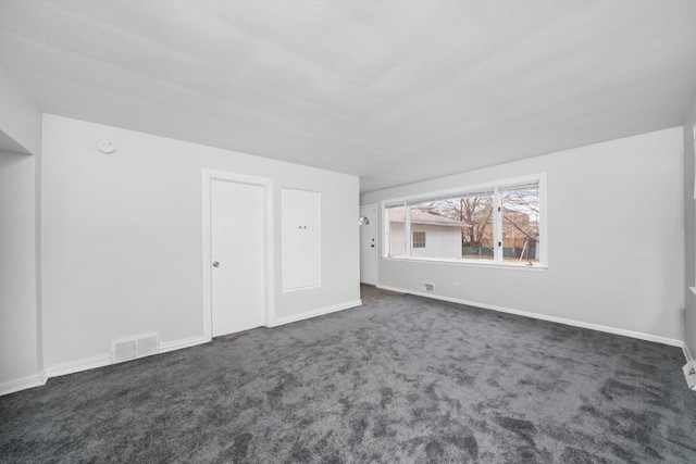 bonus room featuring dark colored carpet, visible vents, and baseboards