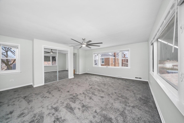 unfurnished bedroom featuring visible vents, baseboards, a ceiling fan, and carpet flooring