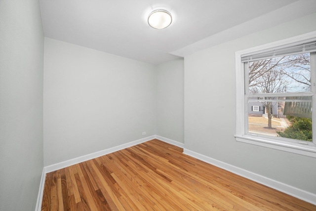 empty room with light wood-type flooring and baseboards