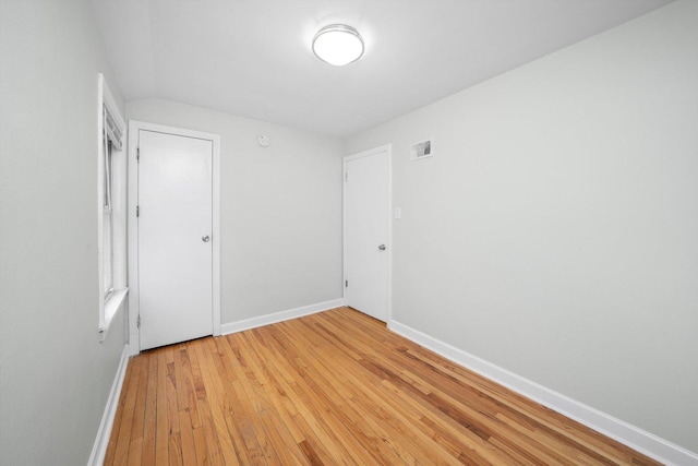 spare room with visible vents, baseboards, and light wood-style flooring