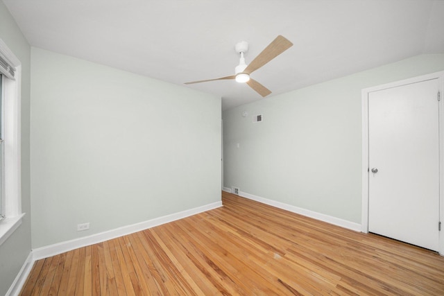 spare room featuring light wood-style flooring, visible vents, baseboards, and ceiling fan