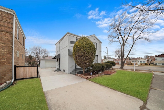 view of property exterior featuring brick siding, a garage, an outdoor structure, a yard, and driveway