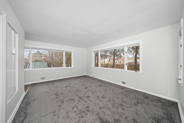 carpeted empty room with visible vents and baseboards