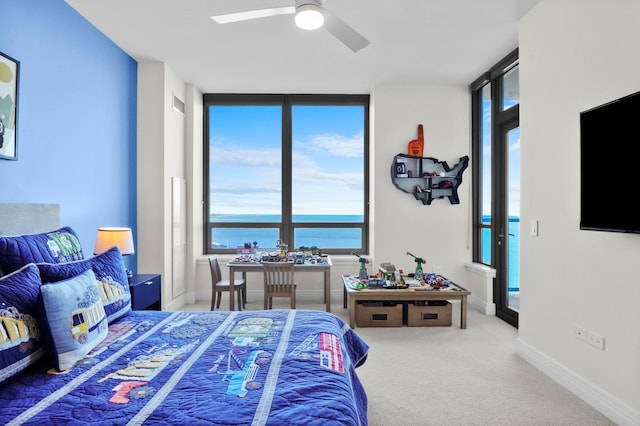 carpeted bedroom featuring baseboards and a ceiling fan