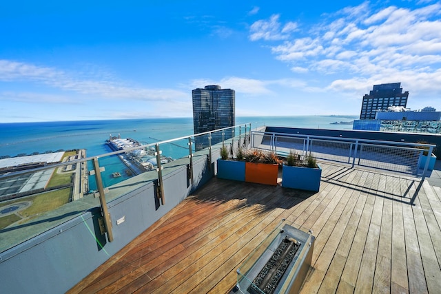 wooden deck featuring a water view and a city view