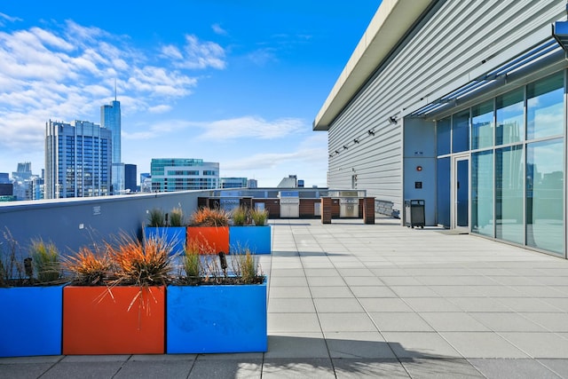 view of patio / terrace featuring exterior kitchen and a city view