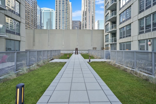 view of property's community with a view of city and fence