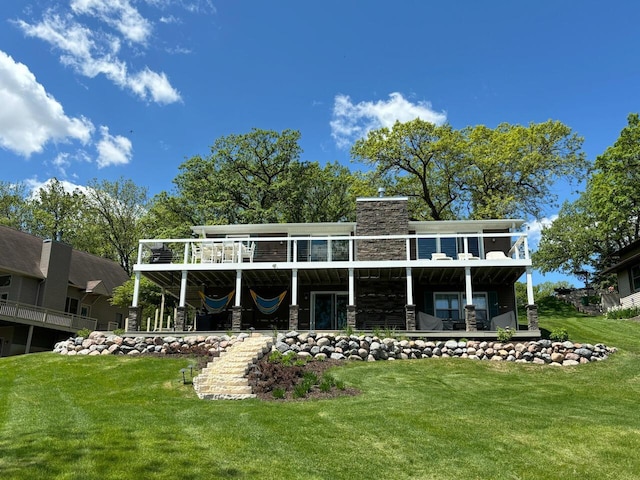 rear view of house with a chimney and a yard