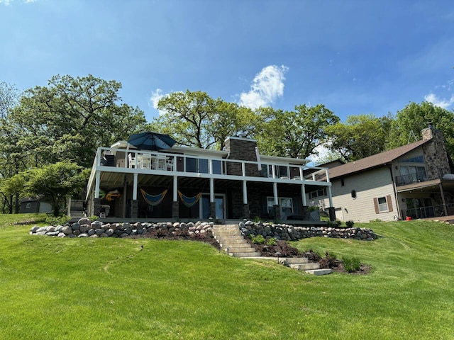 back of property with a lawn and a wooden deck