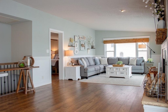 5-124 Sunrise Ct, Lanark, IL 61046 - living room featuring a wainscoted wall, a textured ceiling, vaulted ceiling, and wood finished floors