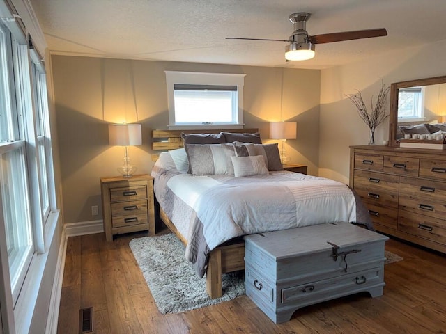 5-124 Sunrise Ct, Lanark, IL 61046 - bedroom featuring baseboards, visible vents, ceiling fan, wood finished floors, and a textured ceiling