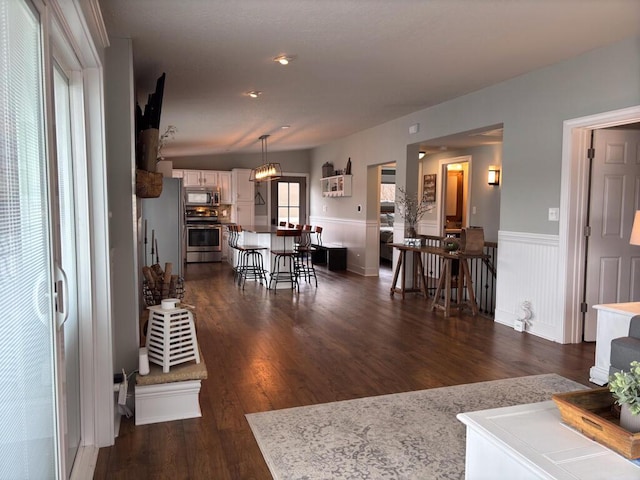 5-124 Sunrise Ct, Lanark, IL 61046 - living area with a wainscoted wall and dark wood-type flooring