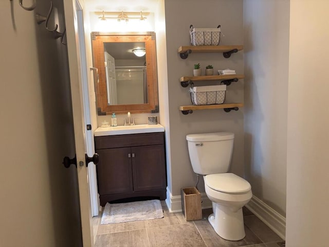 5-124 Sunrise Ct, Lanark, IL 61046 - bathroom featuring vanity, toilet, and baseboards