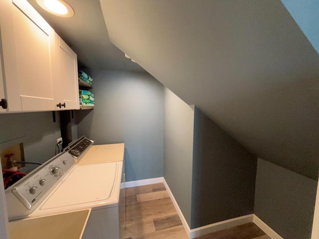 5-124 Sunrise Ct, Lanark, IL 61046 - clothes washing area featuring light wood-type flooring, independent washer and dryer, cabinet space, and baseboards