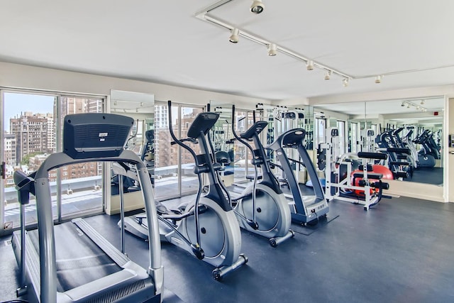 workout area featuring track lighting