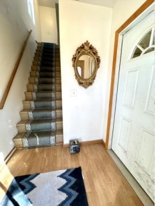 exercise area featuring baseboards and wood finished floors